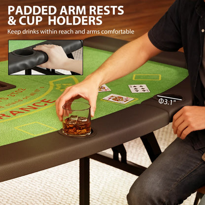 Person holding a glass of whiskey on a gaming table with padded arm rests and cup holders.